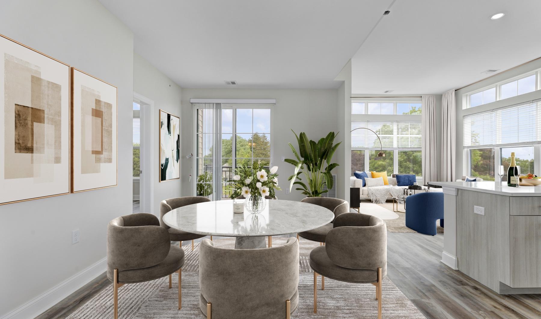 Wide open living areas flooded with natural light a dining room with a table and chairs