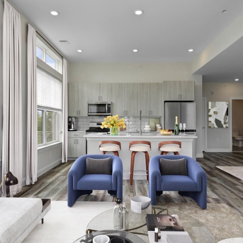 Wide open living areas flooded with natural light a living room with a table and chairs