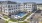 apartment building with a pool in front