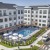apartment building with a pool in front