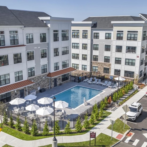 Sparkling swimming pool apartment building with a pool in front