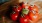 bunch of tomatoes on a wooden plate