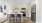 a kitchen with a table chairs and a refrigerator