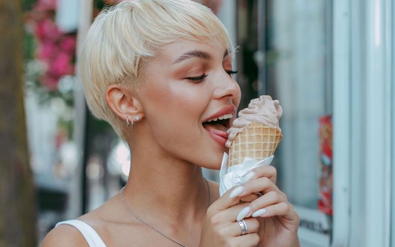 a woman eating ice cream outdoors