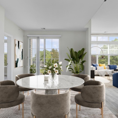 Wide open living areas flooded with natural light a dining room with a table and chairs
