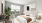a bedroom with a bed and a plant